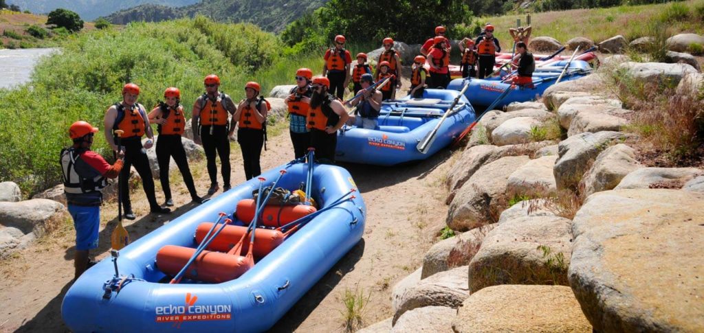 Guides and rafting guests preparing for a raft trip